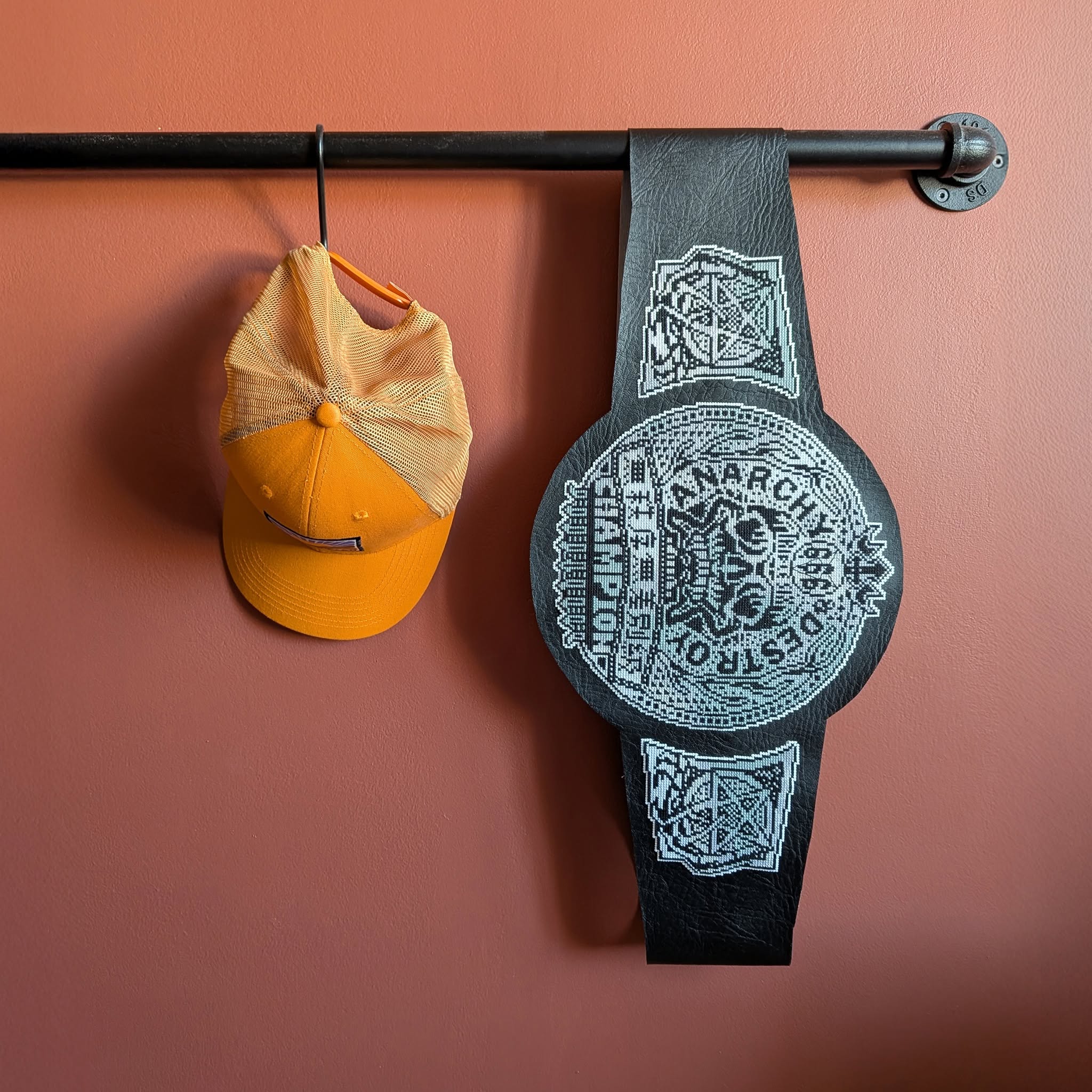 The 666 Disorder Openweight Championship, a title from Japanese promotion Wrestling of Darkness 666, created in cross-stitch.