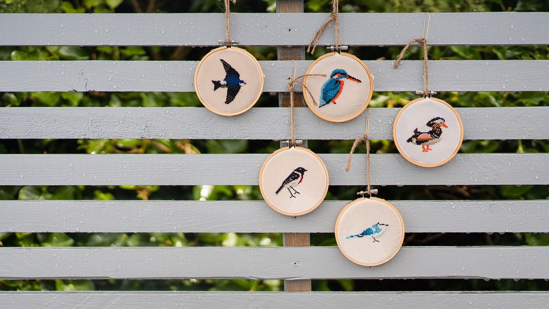 A collection of cross-stitched birds.