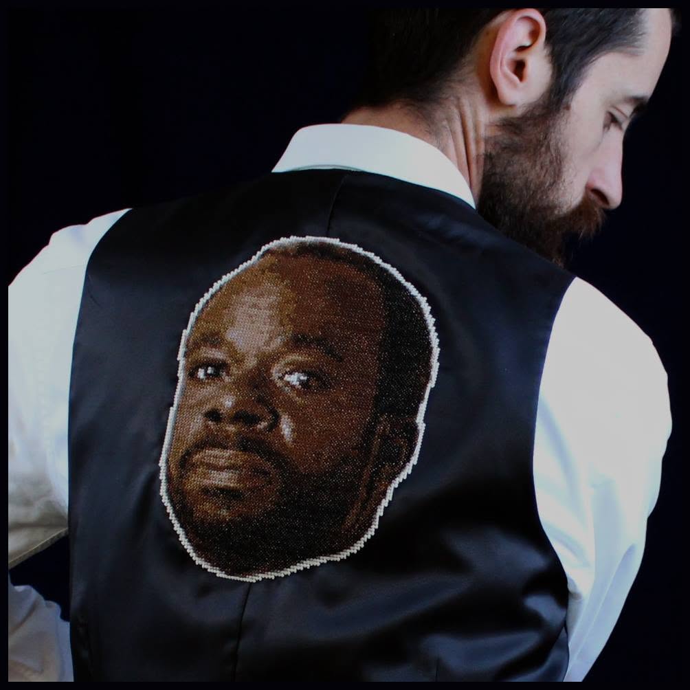 A cross-stitch of Geoffrey, from the Fresh Prince of Bel Air, on a waistcoat.