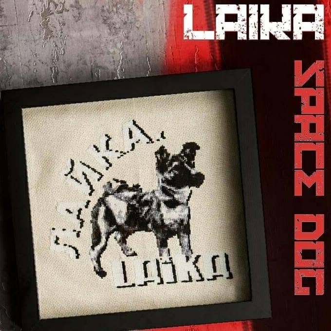 A cross-stitch of Laika, the space dog.