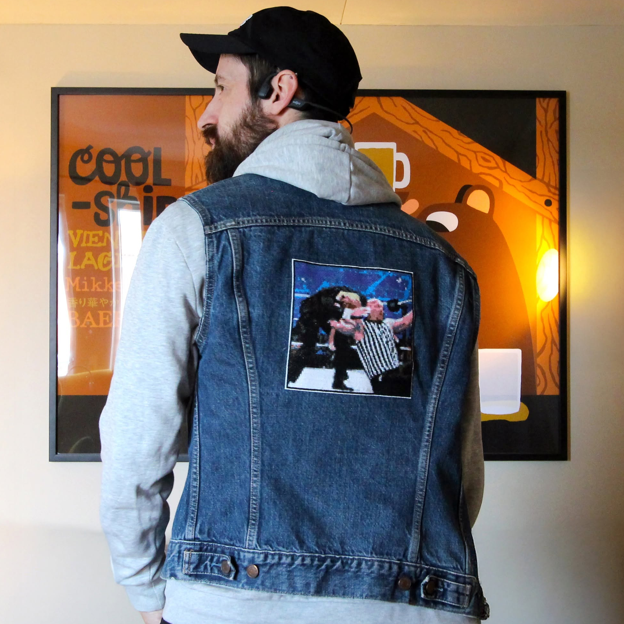 A cross-stitch of Stone Cold Steve Austin, hitting Donald Trump, with a Stone Cold Stunner, attached to a denim jacket.